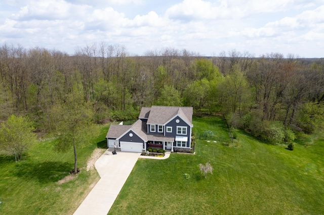 drone / aerial view featuring a view of trees
