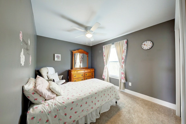 bedroom with a ceiling fan, baseboards, and carpet