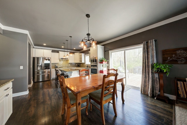 dining room featuring recessed lighting, baseboards, an inviting chandelier, and dark wood finished floors