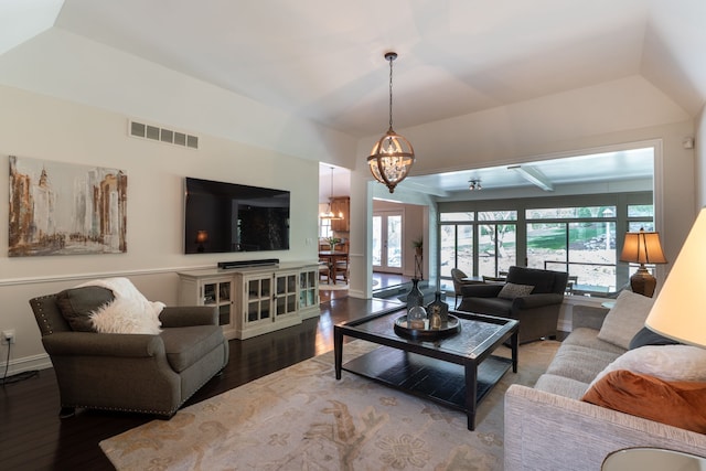 living area with an inviting chandelier, visible vents, wood finished floors, and baseboards
