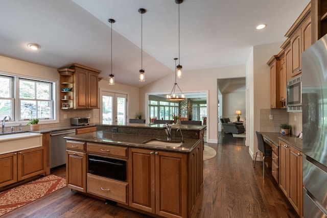 kitchen featuring brown cabinets, stainless steel appliances, open shelves, and a sink