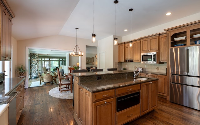 kitchen featuring a sink, stainless steel appliances, brown cabinetry, dark wood-style flooring, and a warming drawer