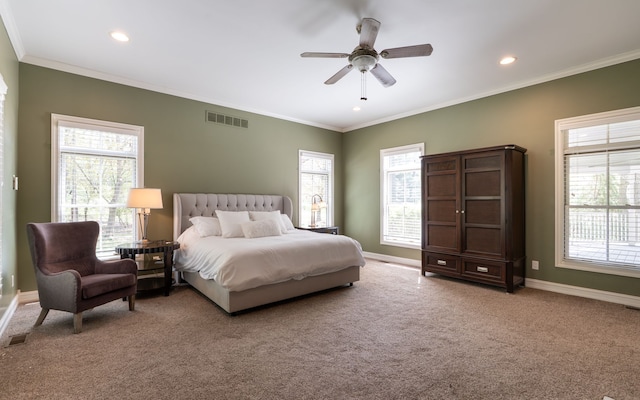 carpeted bedroom with baseboards, visible vents, and multiple windows