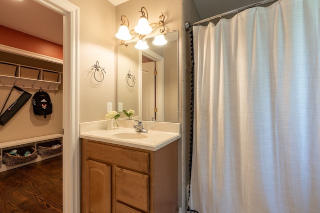 bathroom with curtained shower, vanity, and wood finished floors
