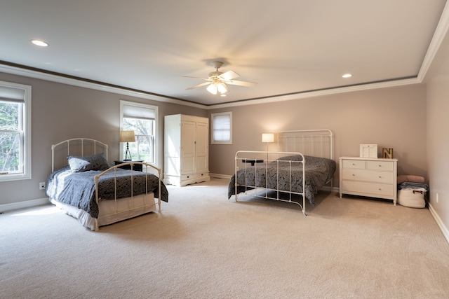 carpeted bedroom featuring multiple windows, crown molding, baseboards, and a ceiling fan
