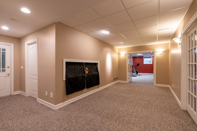 hall with carpet flooring, baseboards, and visible vents