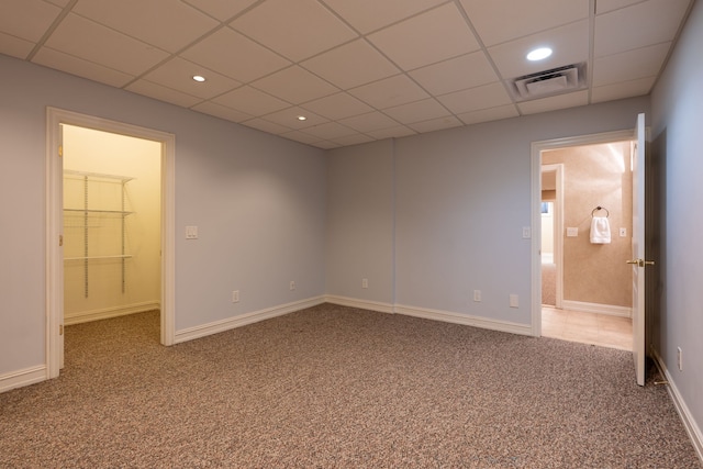 unfurnished bedroom with recessed lighting, carpet floors, visible vents, and a drop ceiling