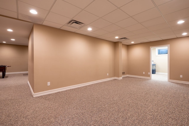 finished basement with a drop ceiling, visible vents, and carpet floors