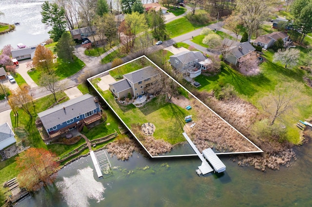 drone / aerial view with a water view and a residential view