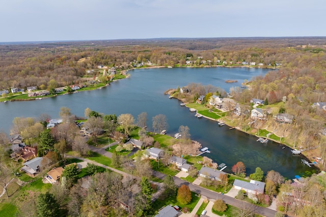 birds eye view of property with a water view, a view of trees, and a residential view