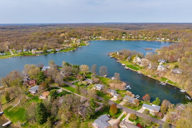 bird's eye view featuring a water view, a residential view, and a wooded view