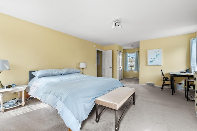 bedroom with baseboards, light carpet, and visible vents