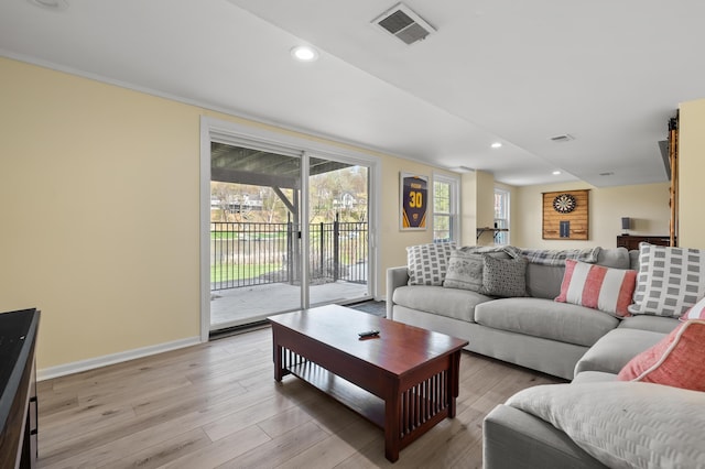 living room featuring recessed lighting, wood finished floors, and visible vents