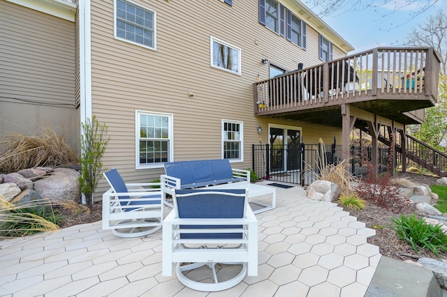 view of patio featuring an outdoor living space, a wooden deck, and stairs
