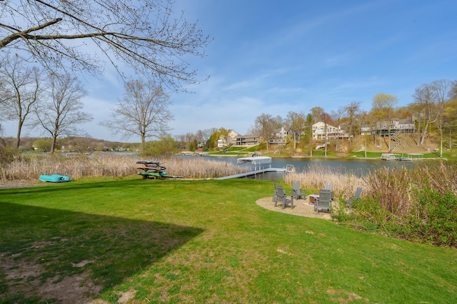 view of yard featuring a water view and a residential view
