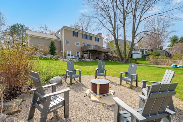 exterior space with an outdoor fire pit, a deck, and stairway