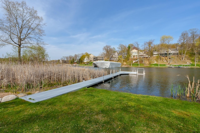 view of dock featuring a lawn, a water view, and a residential view