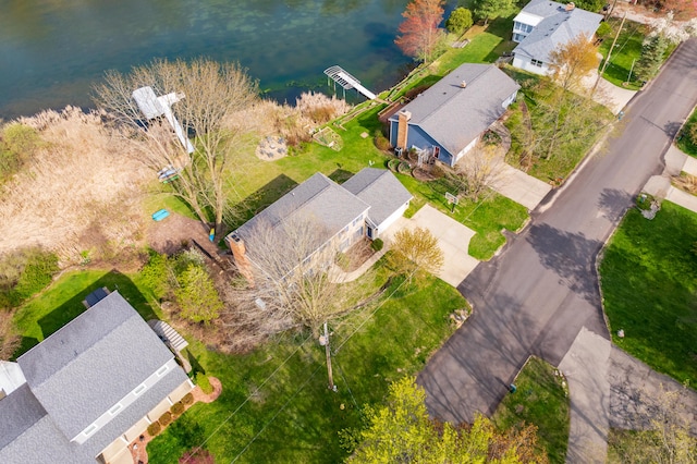 drone / aerial view featuring a residential view and a water view