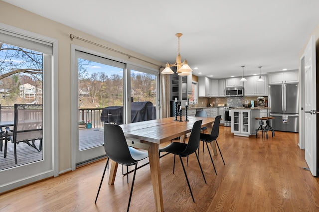 dining space featuring light wood-style floors, recessed lighting, and a healthy amount of sunlight