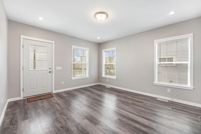 foyer entrance featuring recessed lighting, baseboards, dark wood-style flooring, and visible vents