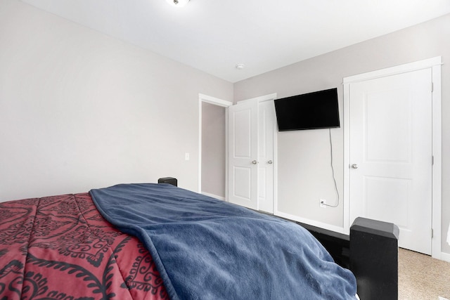 bedroom featuring baseboards and light colored carpet