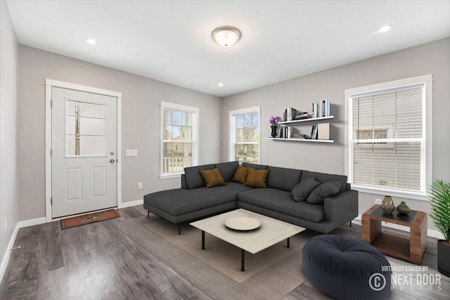 living area featuring baseboards, recessed lighting, and wood finished floors