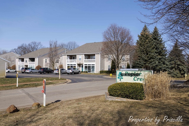 3025 Poplar Creek Dr SE Unit 104, Grand Rapids, MI 49512 - view of asphalt road with a residential view