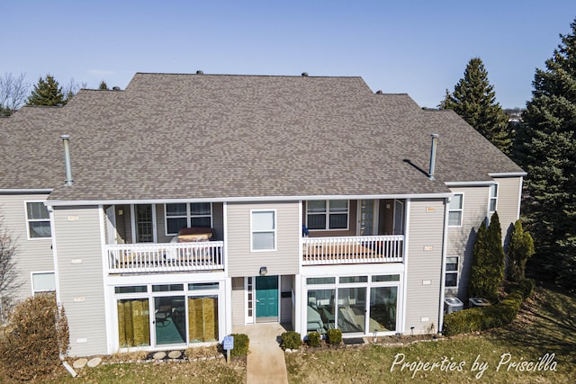 3025 Poplar Creek Dr SE Unit 104, Grand Rapids, MI 49512 - back of property with a balcony, a shingled roof, and central AC unit
