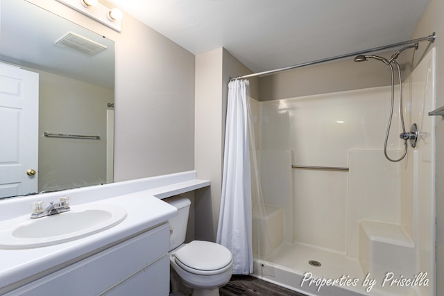 3025 Poplar Creek Dr SE Unit 104, Grand Rapids, MI 49512 - bathroom with vanity, toilet, a shower with shower curtain, and wood finished floors