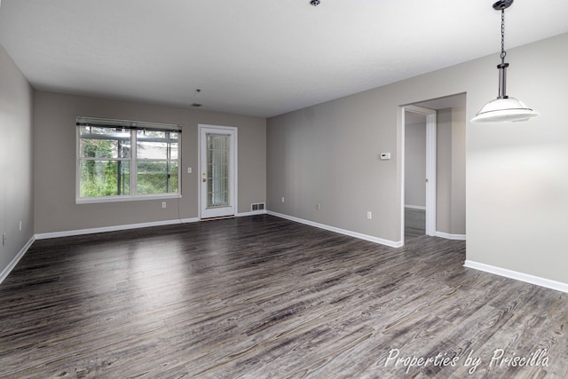 3025 Poplar Creek Dr SE Unit 104, Grand Rapids, MI 49512 - unfurnished room with dark wood-type flooring and baseboards