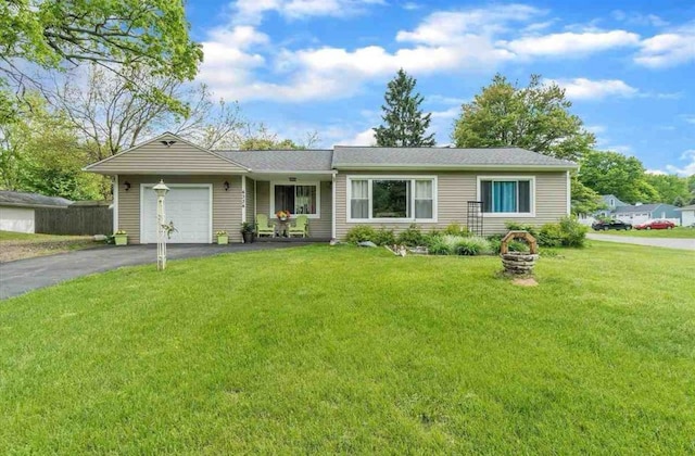 single story home with an attached garage, driveway, and a front yard
