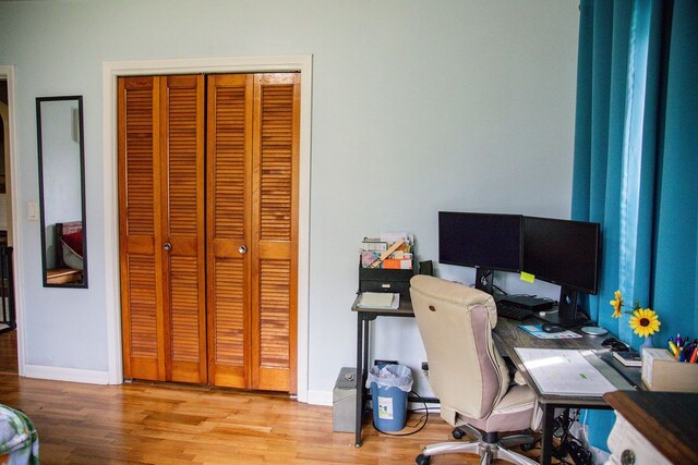 office with baseboards and wood finished floors