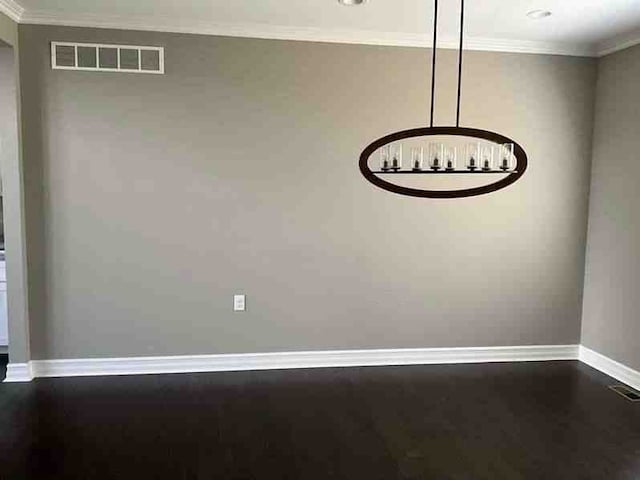 interior space featuring baseboards, ornamental molding, a notable chandelier, and visible vents