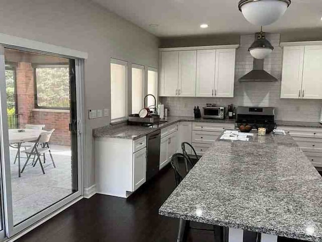 kitchen featuring light stone countertops, dishwasher, white cabinets, stainless steel range with gas cooktop, and wall chimney exhaust hood