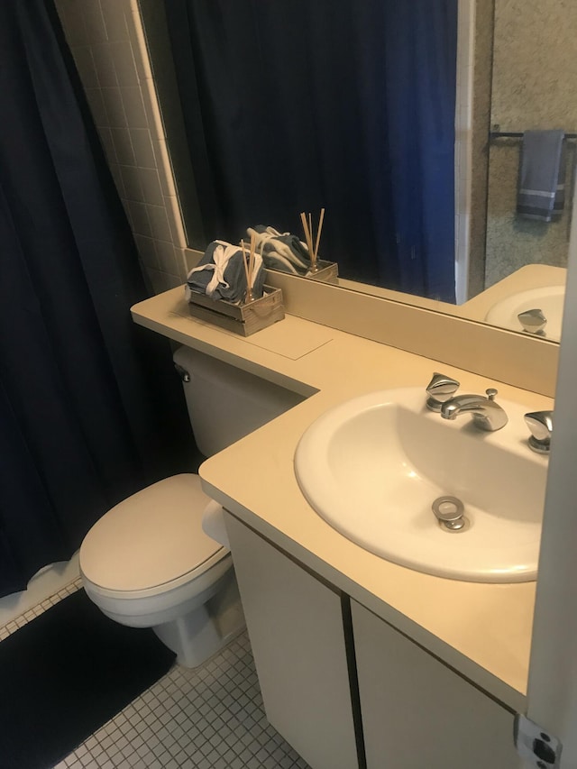 bathroom featuring vanity, tile patterned flooring, a shower with curtain, and toilet