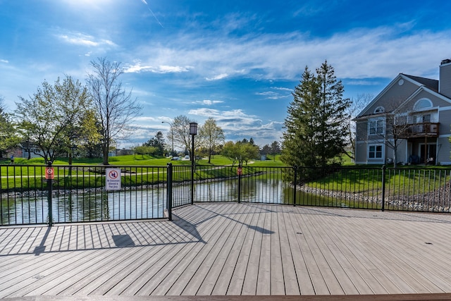 wooden deck featuring a water view