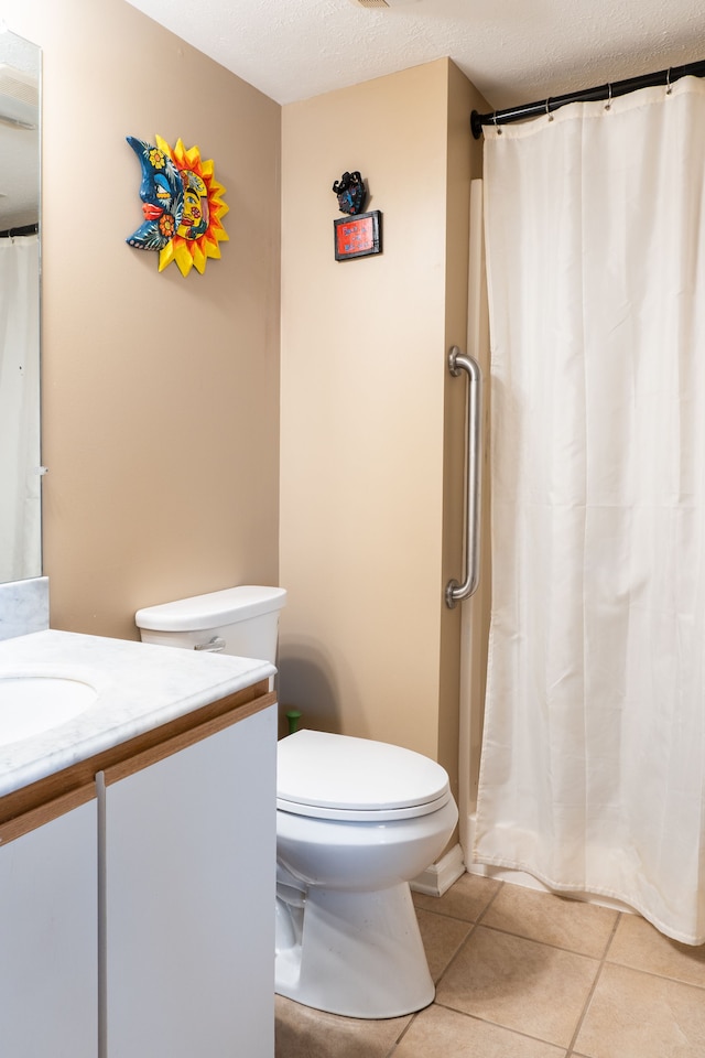 1533 Weatherstone Dr, Ann Arbor, MI 48108 - bathroom featuring tile patterned flooring, vanity, toilet, a textured ceiling, and a shower with shower curtain