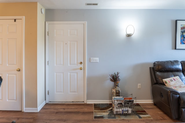entrance foyer with baseboards, wood finished floors, and visible vents