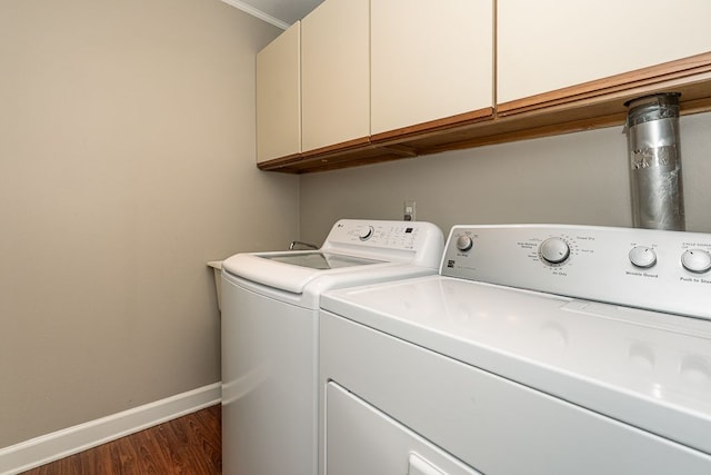 laundry area with cabinet space, crown molding, separate washer and dryer, baseboards, and dark wood-style floors
