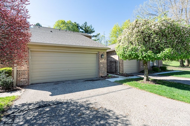 view of front of house featuring brick siding and a garage