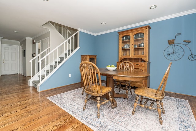 dining area with stairs, recessed lighting, baseboards, and wood finished floors