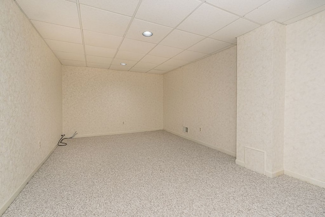 carpeted spare room with baseboards, recessed lighting, a textured wall, and a paneled ceiling
