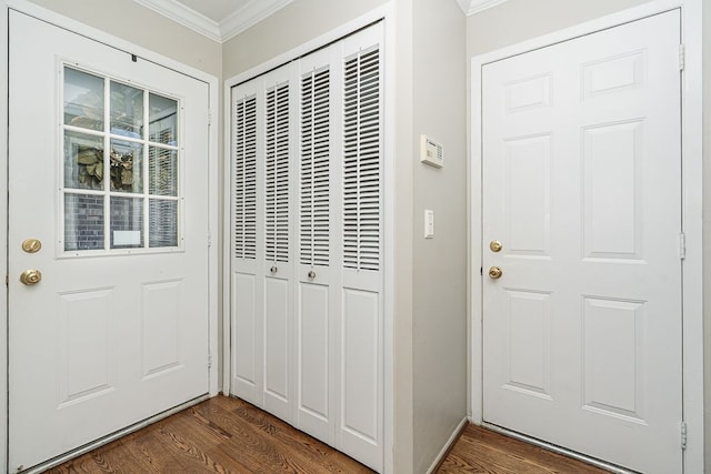 entryway with ornamental molding and dark wood-style flooring