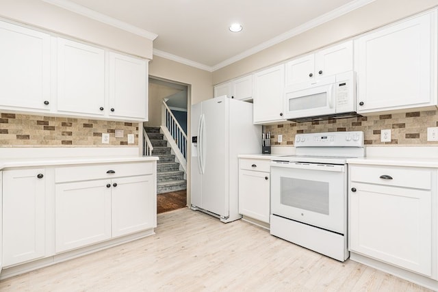 kitchen with light countertops, white appliances, and tasteful backsplash
