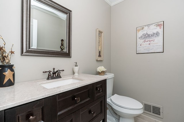 bathroom featuring crown molding, vanity, toilet, tile patterned floors, and visible vents