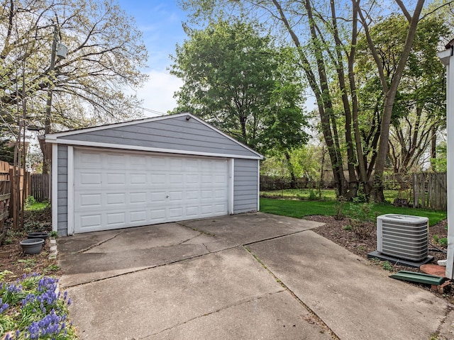 detached garage with fence and cooling unit