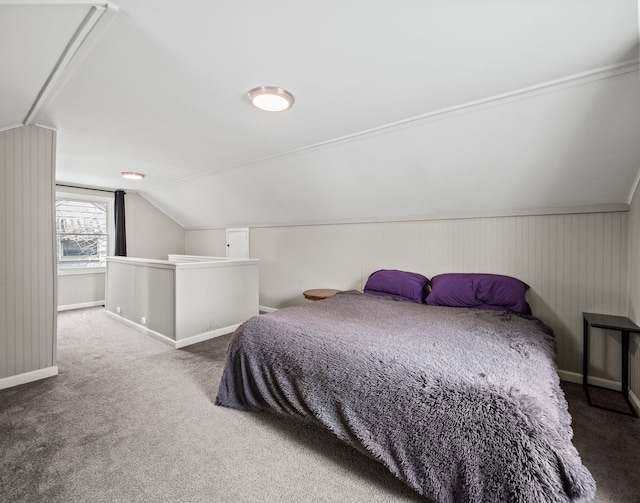 carpeted bedroom with baseboards and vaulted ceiling