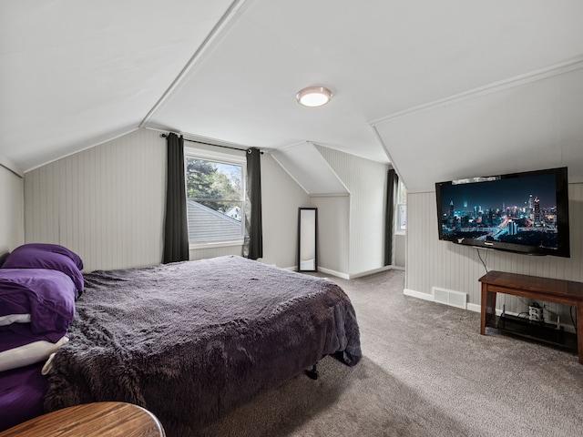bedroom featuring baseboards, carpet, lofted ceiling, and visible vents