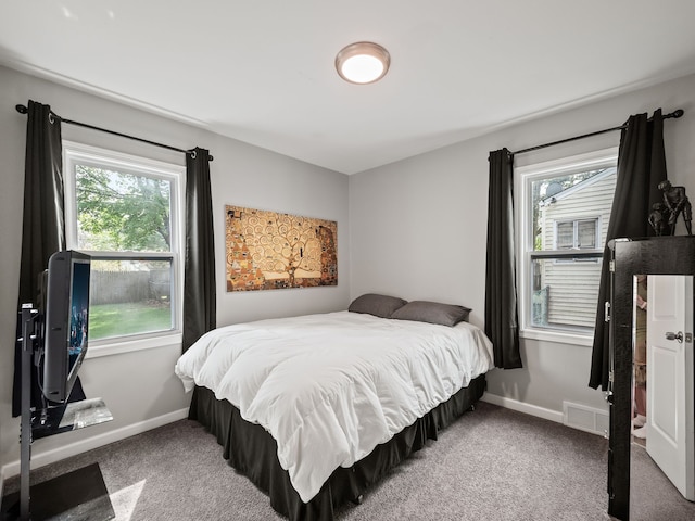 bedroom with baseboards, multiple windows, carpet, and visible vents