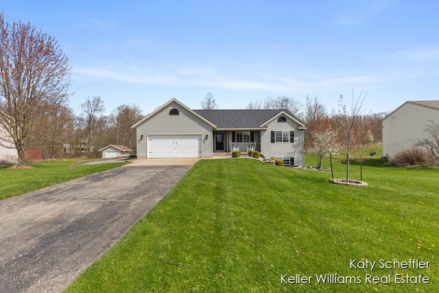ranch-style house featuring an attached garage, driveway, and a front yard